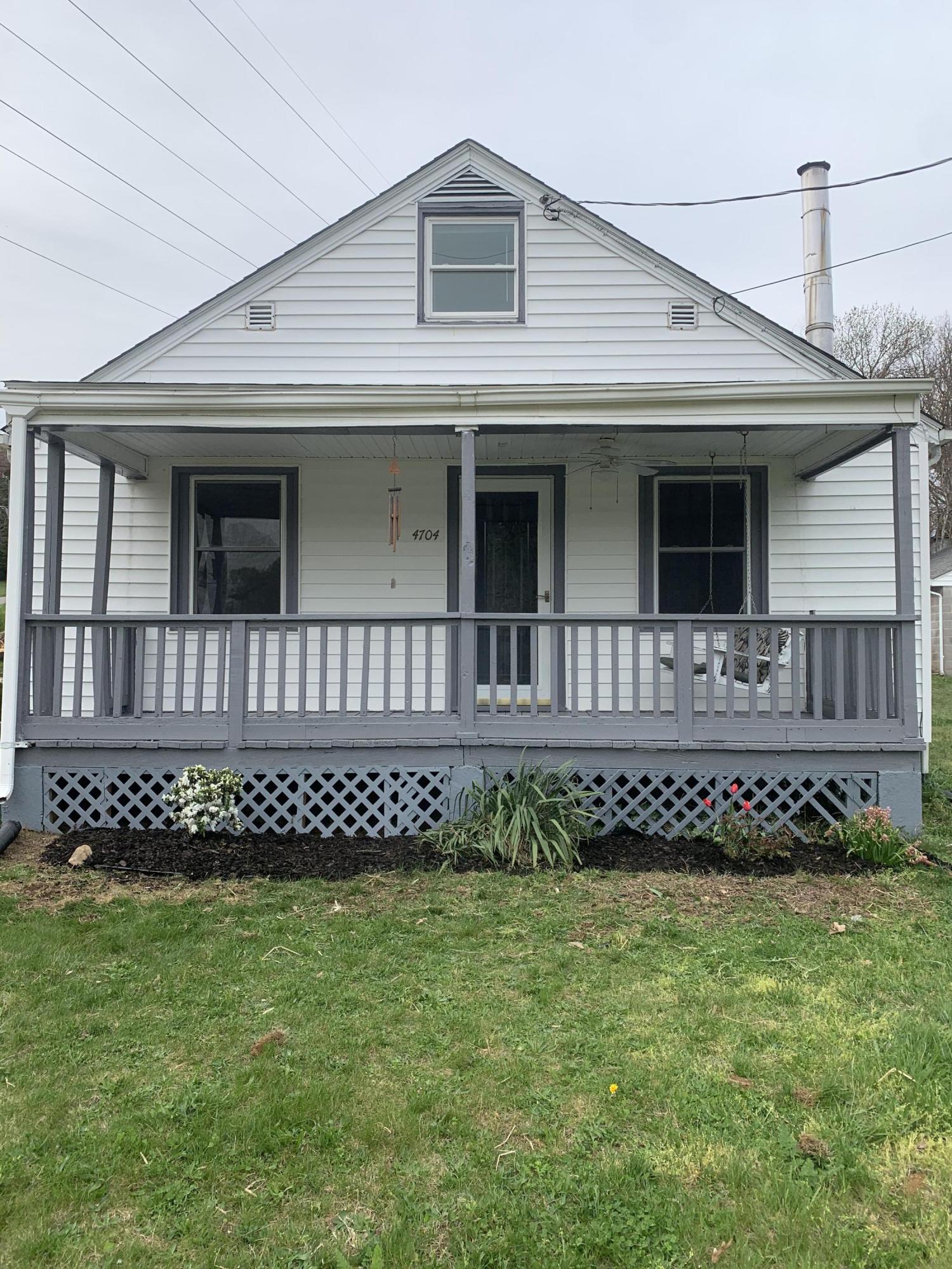 4704 Goodman Road Roanoke, VA 24014 - Photo 2 of 25 a front view of a house with a garden