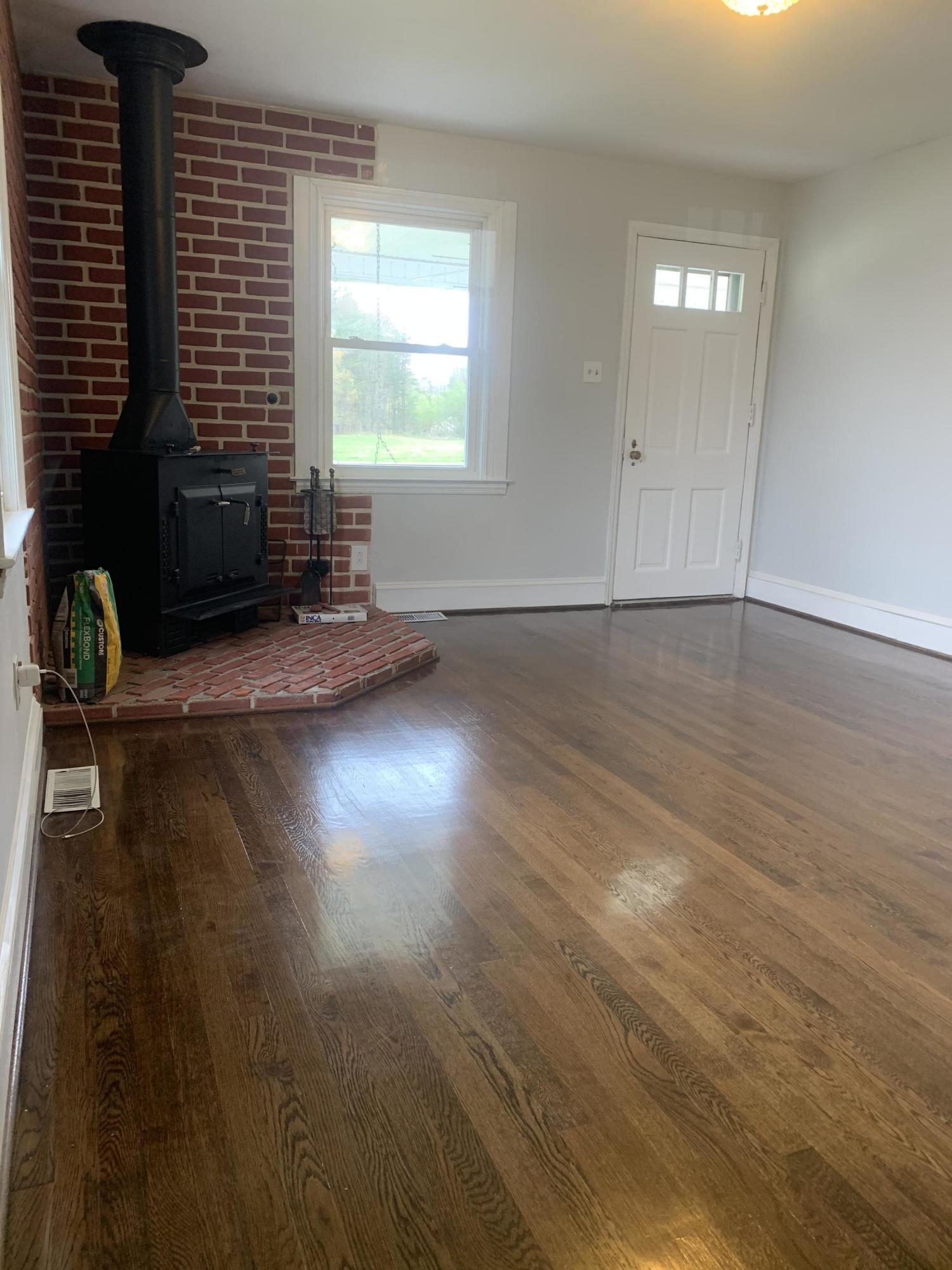 4704 Goodman Road Roanoke, VA 24014 - Photo 4 of 25 an empty room with wooden floor and windows