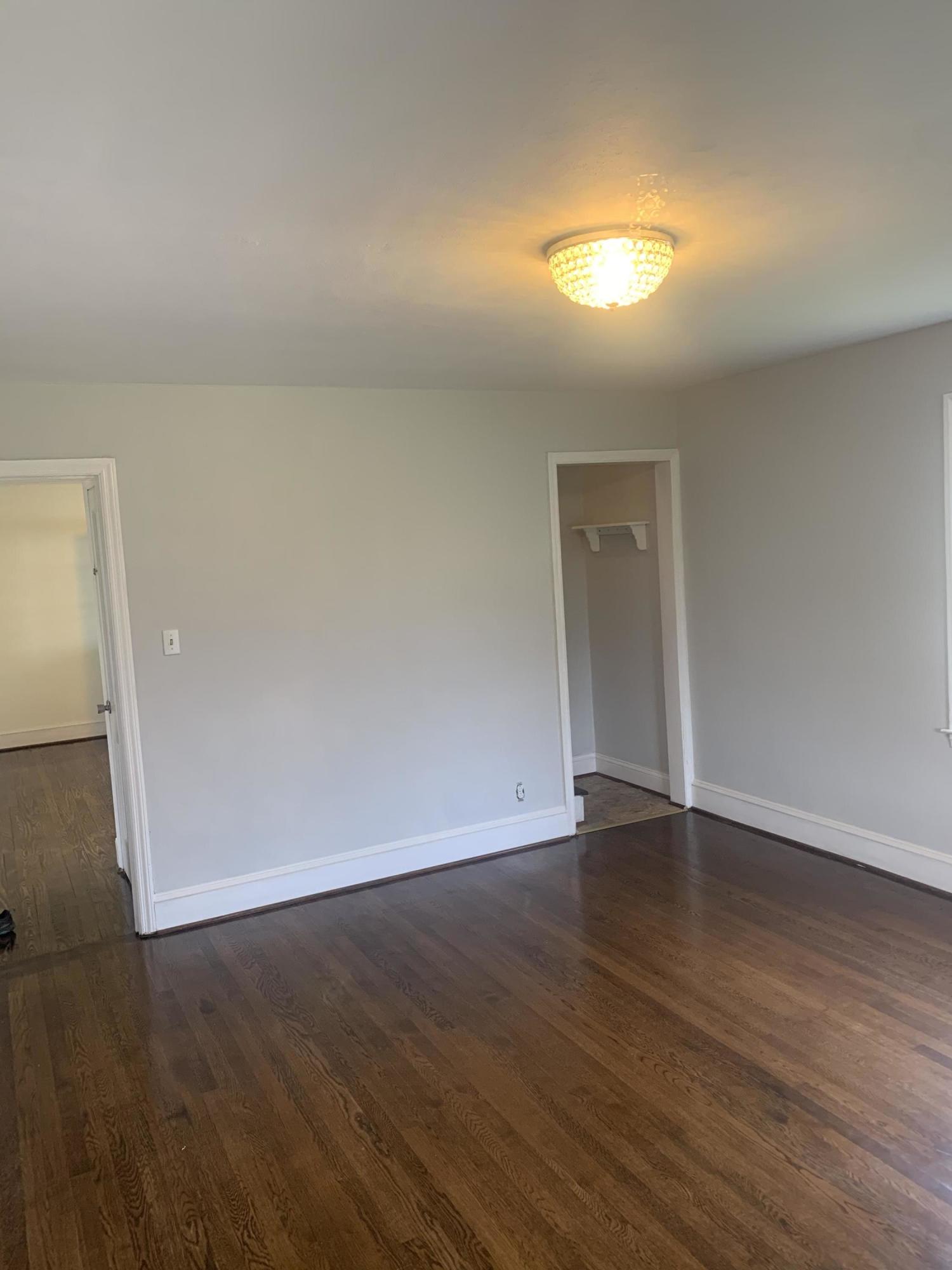 4704 Goodman Road Roanoke, VA 24014 - Photo 6 of 25 a view of an empty room and wooden floor and a window
