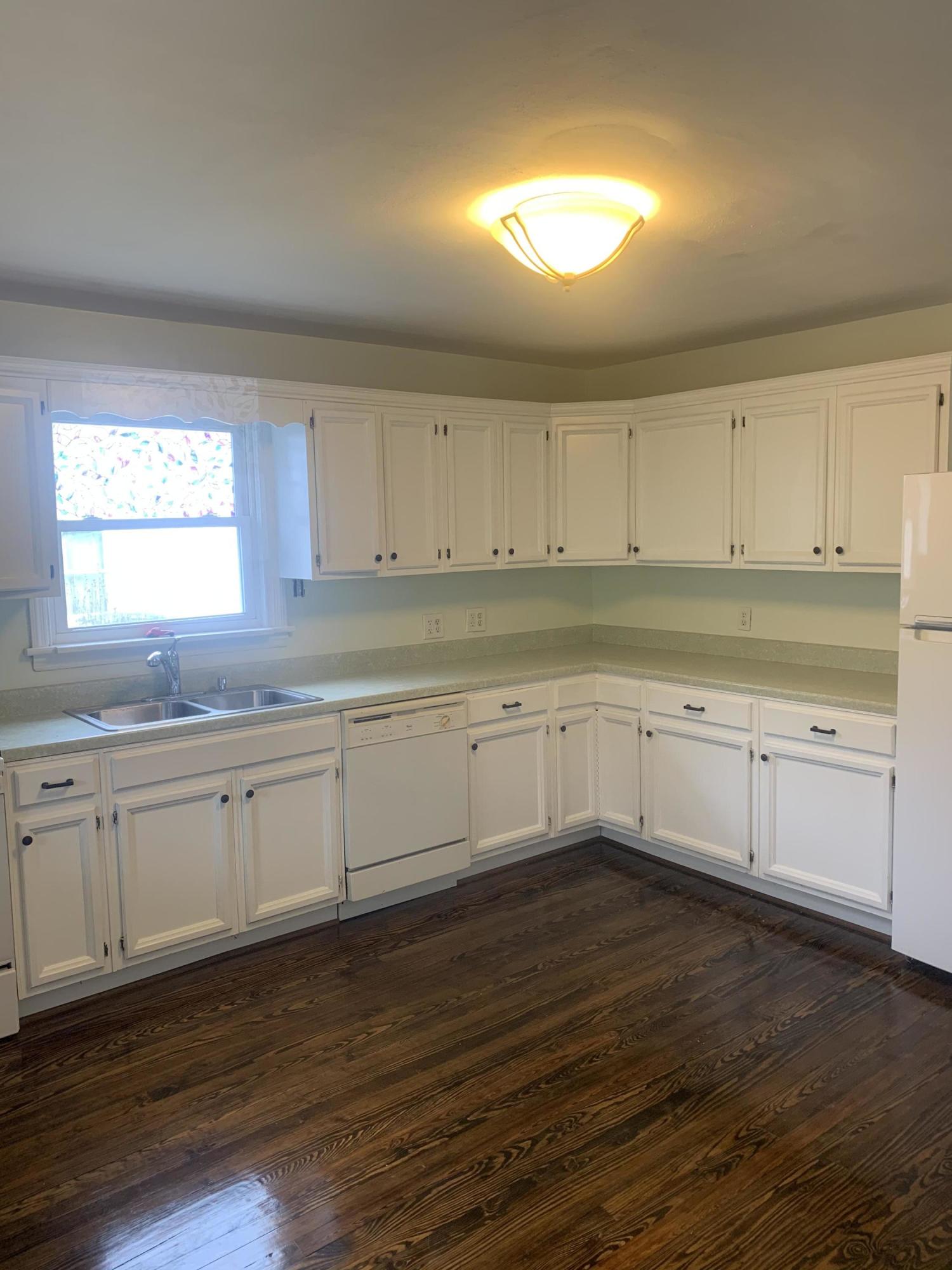 4704 Goodman Road Roanoke, VA 24014 - Photo 8 of 25 a kitchen with granite countertop white cabinets and white stainless steel appliances