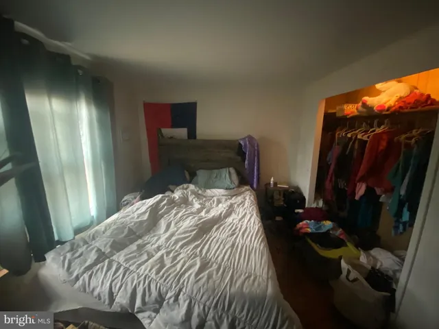 a bedroom with a bed and a mirror