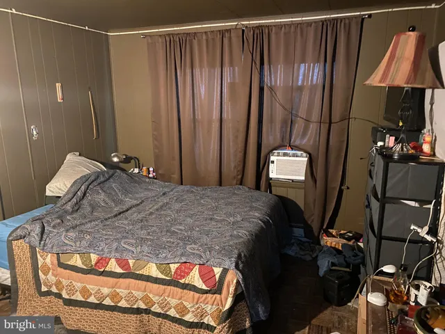 a bedroom with a bed and a mirror