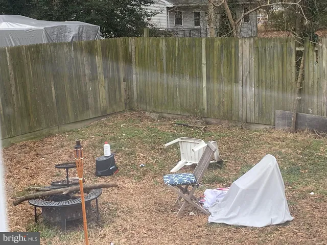 a view of a backyard with table and chairs