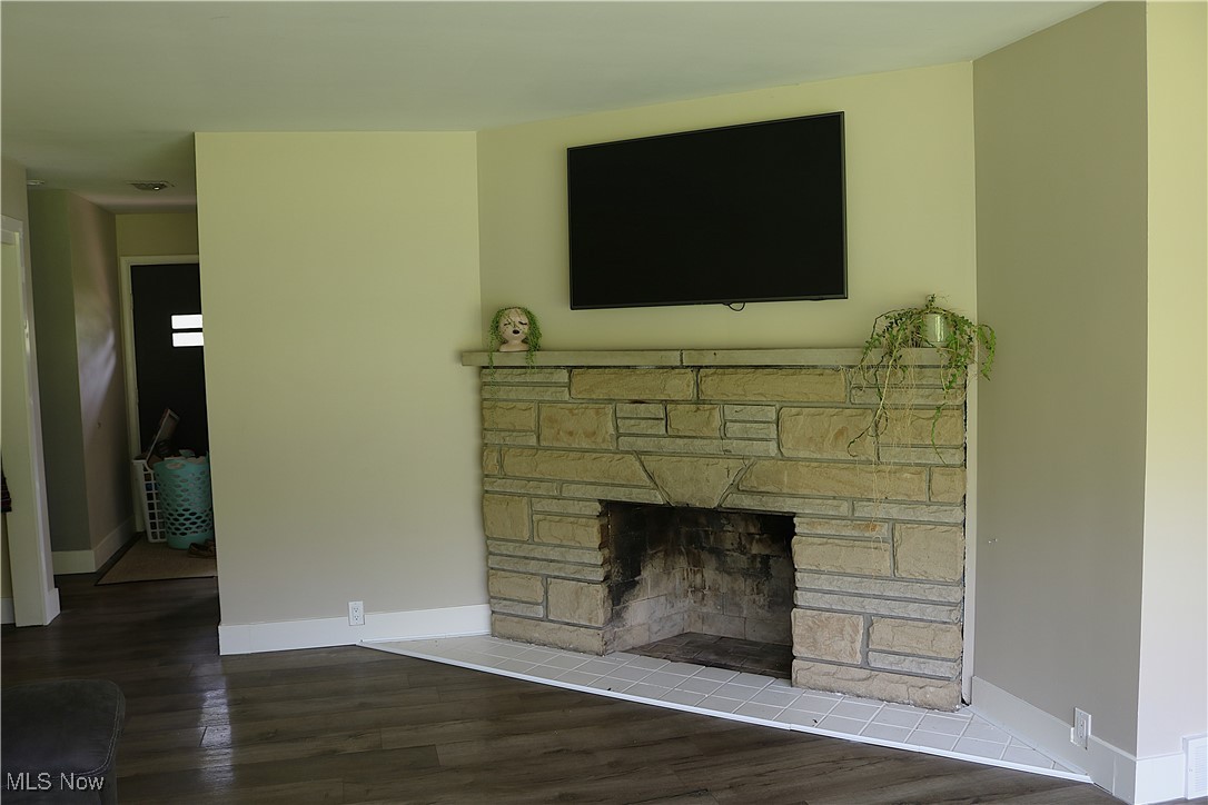 14485 Bass Lake Road Newbury, OH 44065 - Photo 15 of 22 Unfurnished living room featuring a stone fireplace and wood finished floors