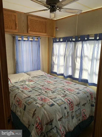 a bed sitting in a room next to a window