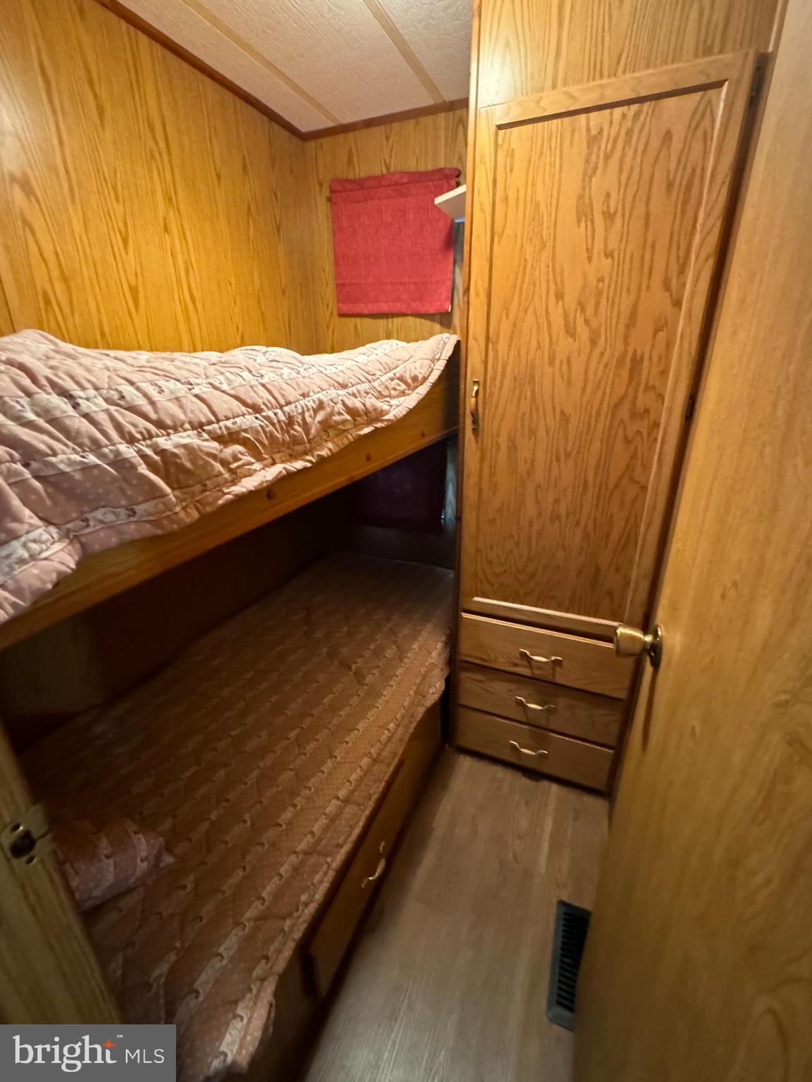 148 Ocean Oval Drive Berlin, MD 21811 - Photo 17 of 29 a bedroom with a bed and wooden floor