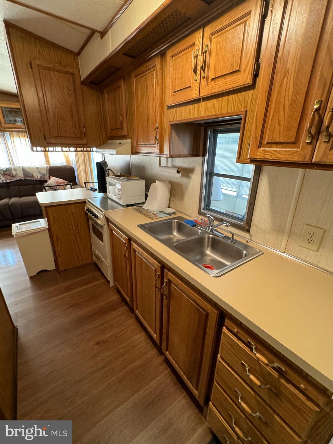 148 Ocean Oval Drive Berlin, MD 21811 - Photo 20 of 29 a kitchen with a stove a sink and a microwave