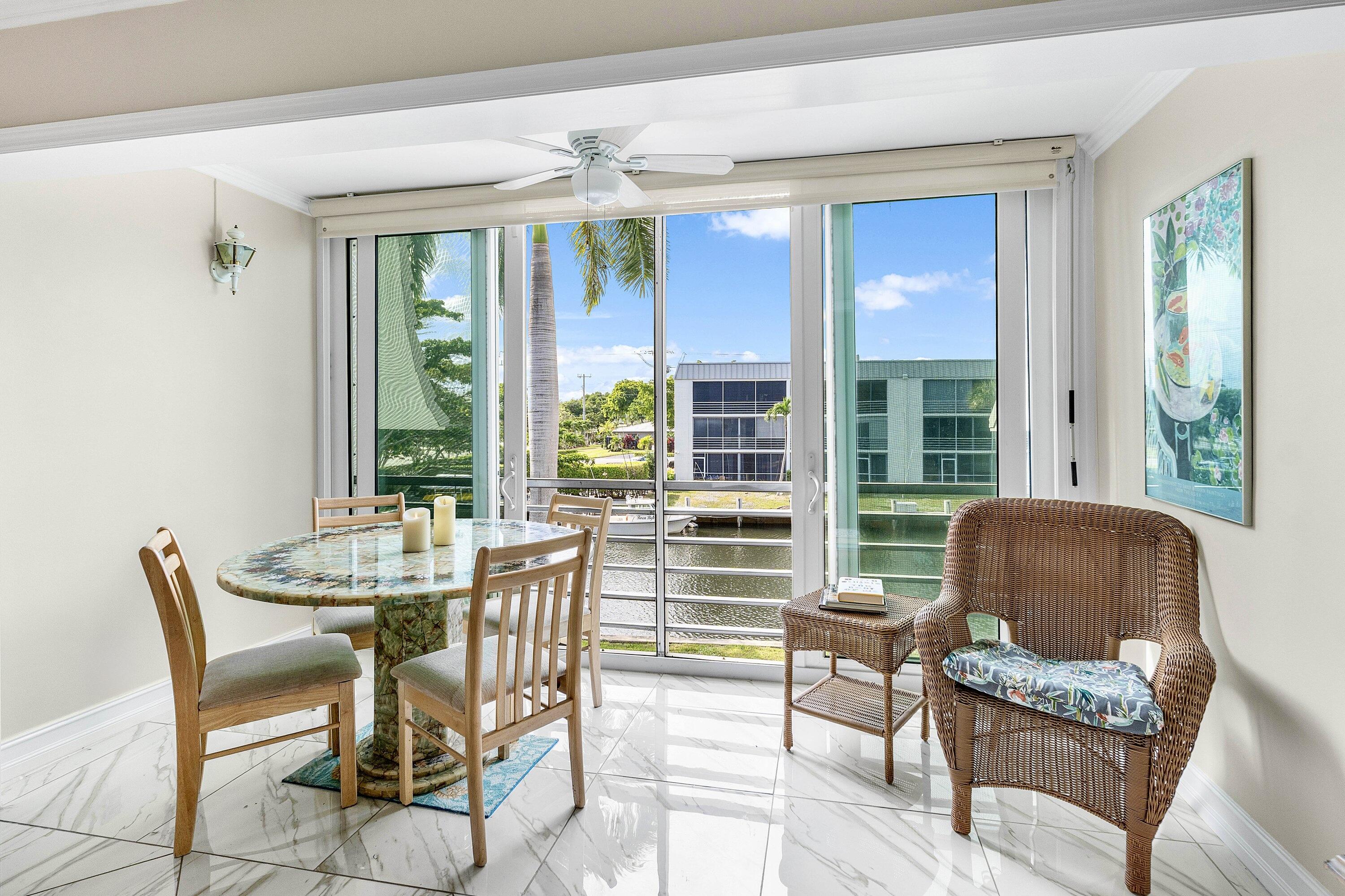 765 Jeffery Street, Unit 1203 Boca Raton, FL 33487 - Photo 11 of 31 a dining room with furniture and large windows