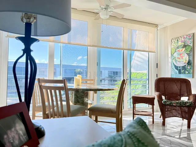 a view of a livingroom with furniture and a floor to ceiling window