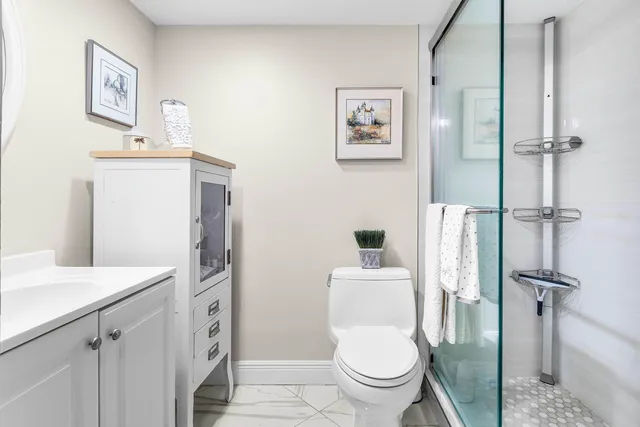a white toilet sitting next to a bathroom sink