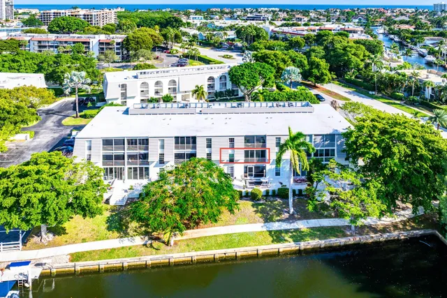 an aerial view of residential houses with outdoor space and swimming pool