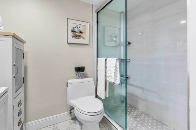 a white toilet sitting next to a bathroom sink