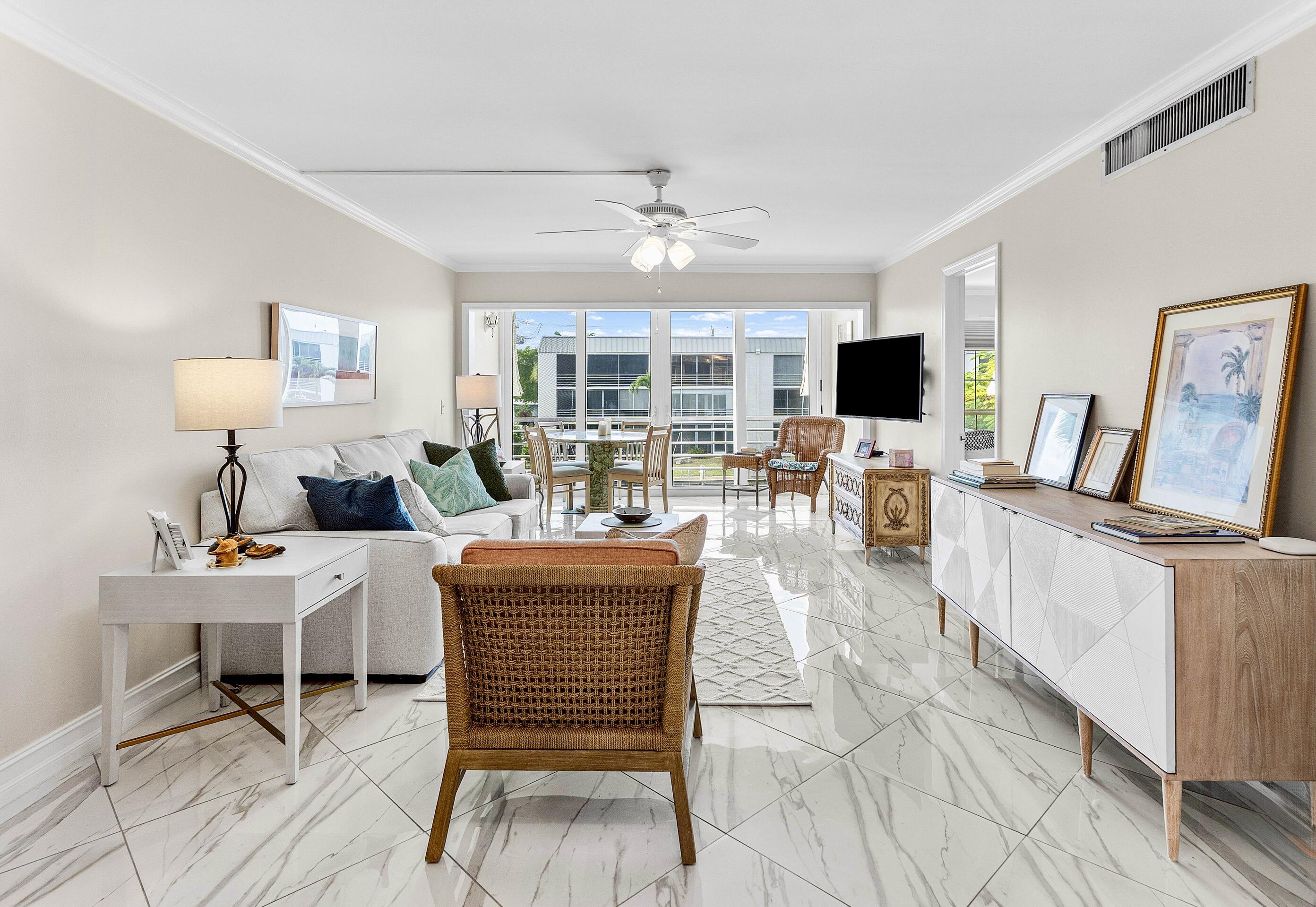 765 Jeffery Street, Unit 1203 Boca Raton, FL 33487 - Photo 22 of 31 a living room with furniture a fireplace and a flat screen tv