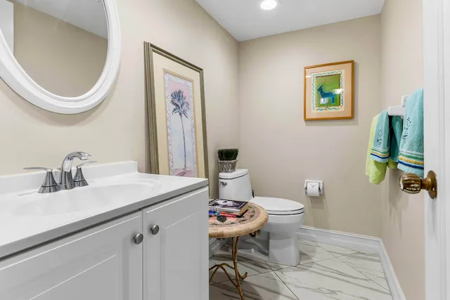 a bathroom with a toilet a sink and a mirror