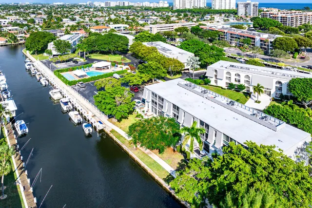 an aerial view of residential houses with outdoor space and swimming pool