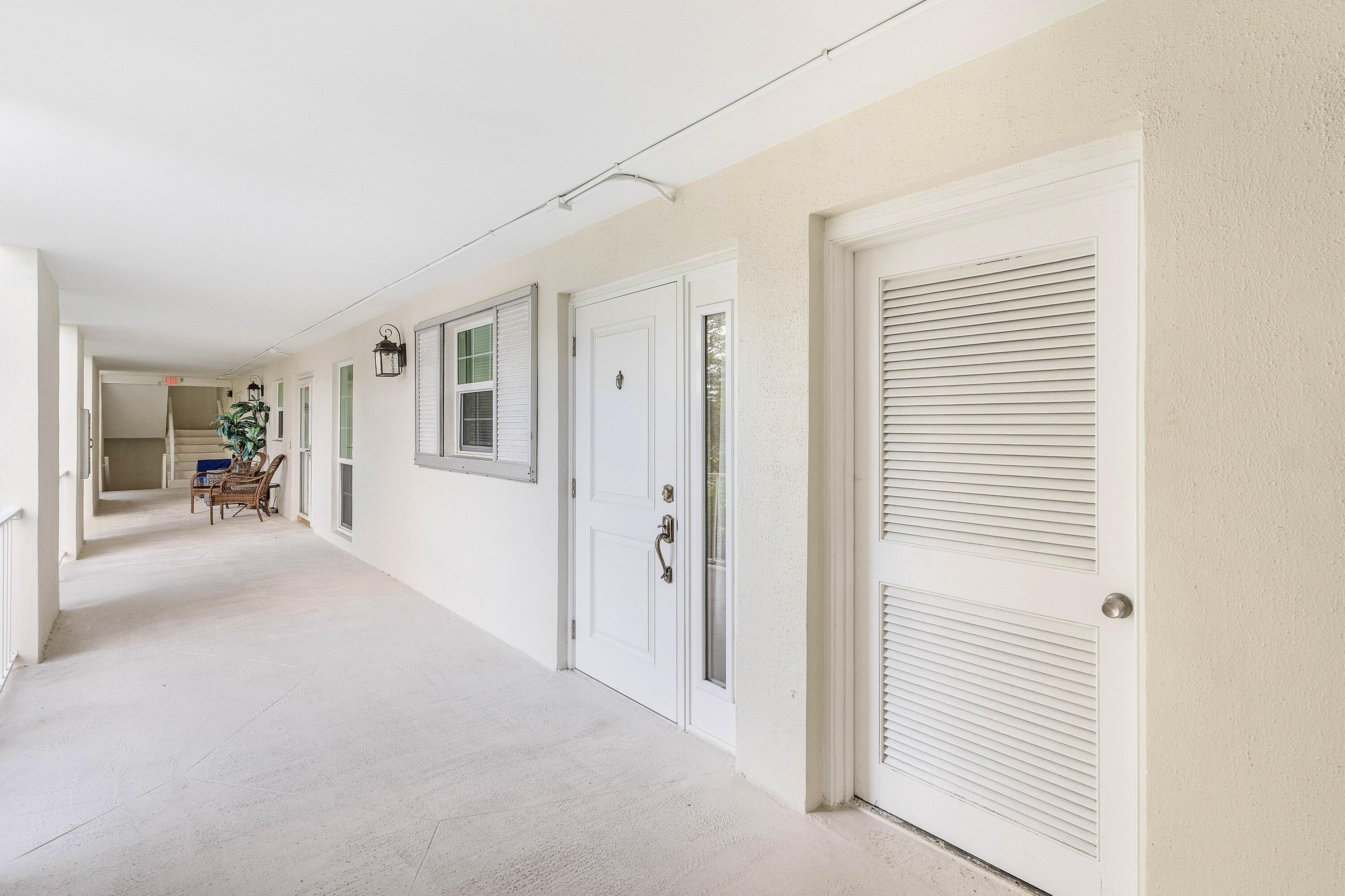 765 Jeffery Street, Unit 1203 Boca Raton, FL 33487 - Photo 3 of 31 a view of a livingroom with wooden floor and a bathroom