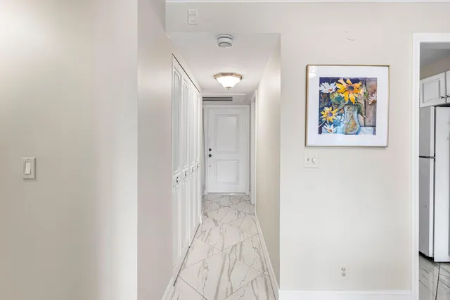 a view of a hallway with a painting on the wall