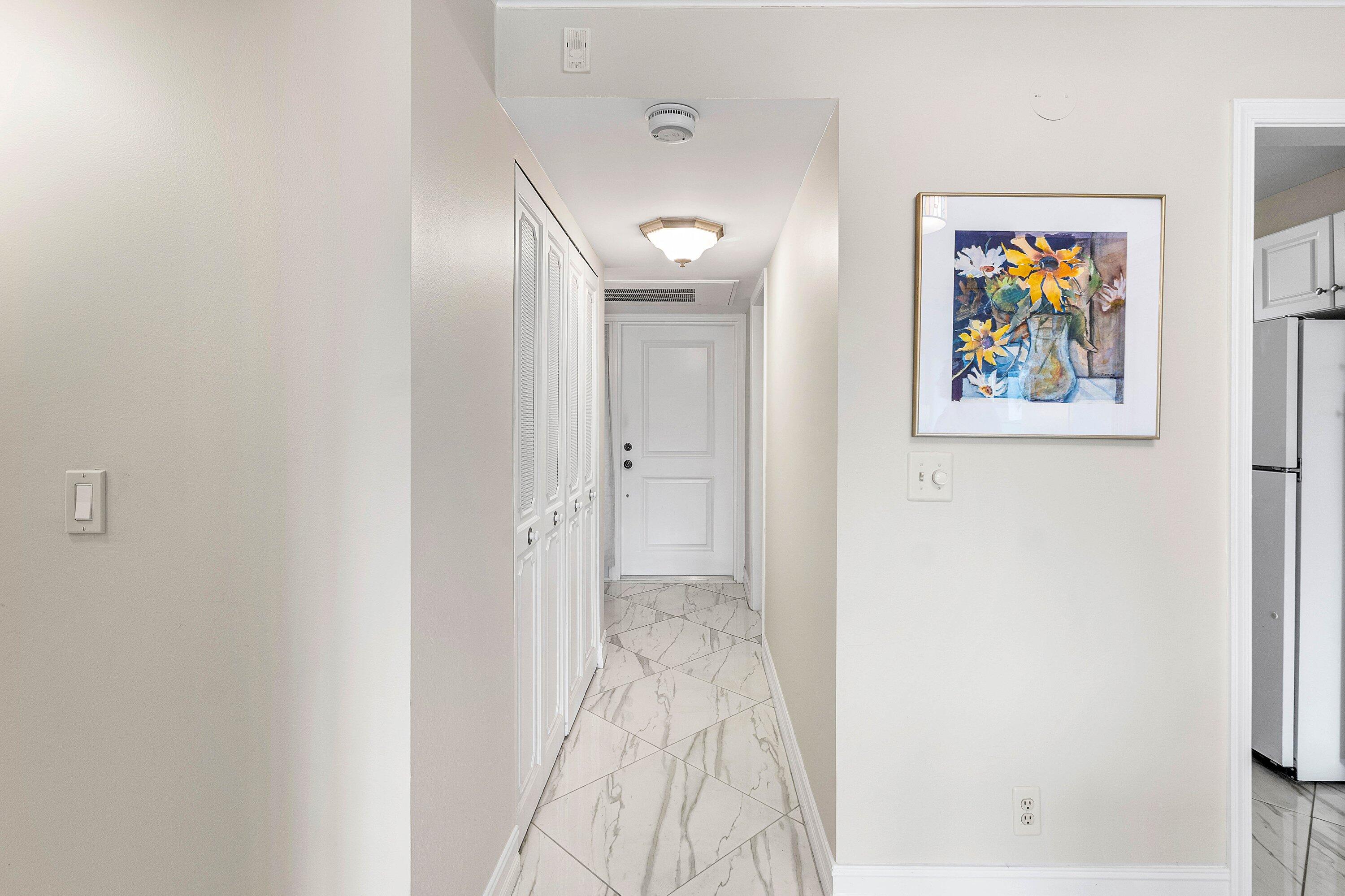 765 Jeffery Street, Unit 1203 Boca Raton, FL 33487 - Photo 6 of 31 a view of a hallway with a painting on the wall