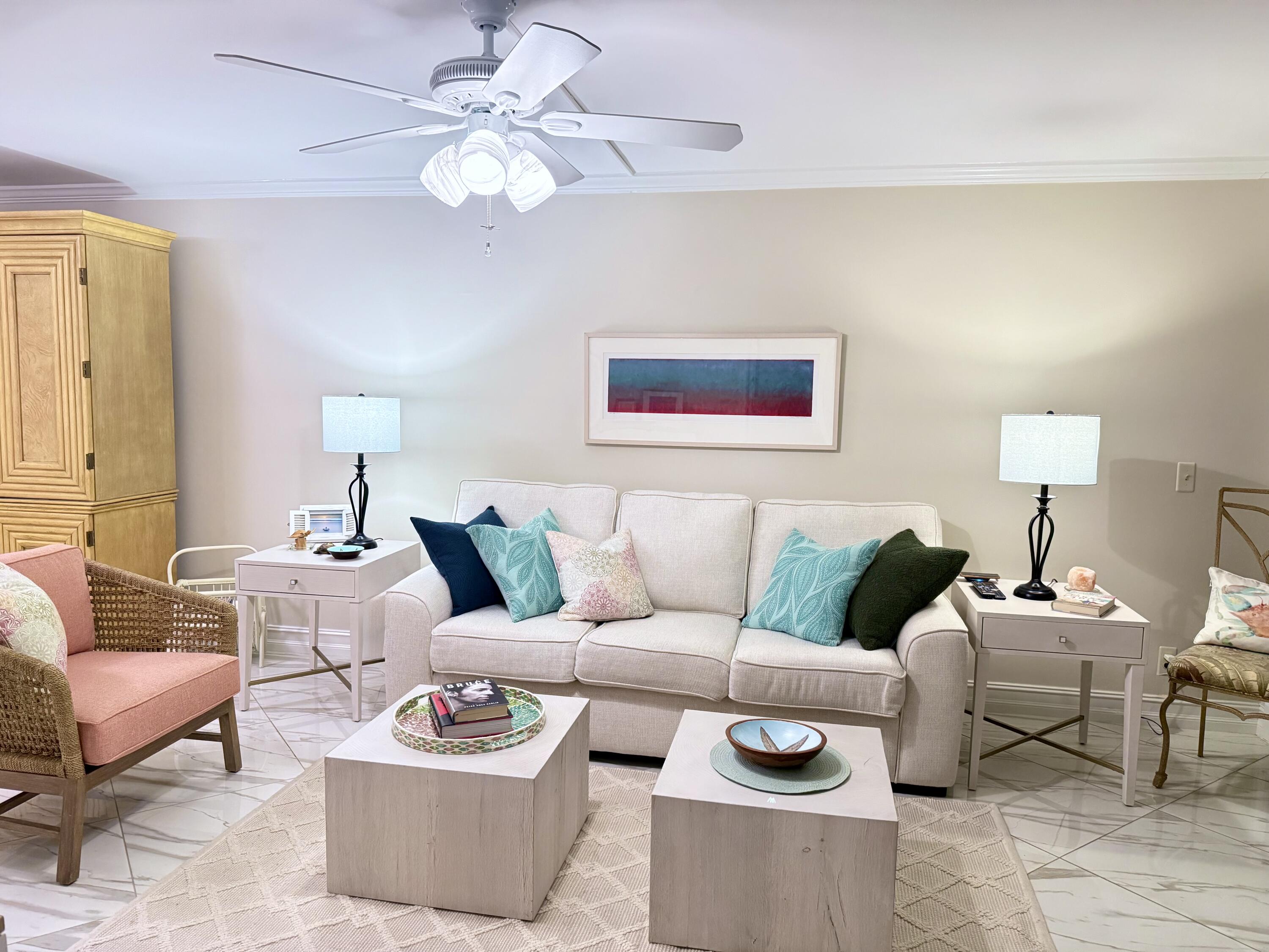 765 Jeffery Street, Unit 1203 Boca Raton, FL 33487 - Photo 7 of 31 a living room with furniture a rug and a chandelier