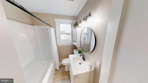 a bathroom with a sink a mirror and a shower