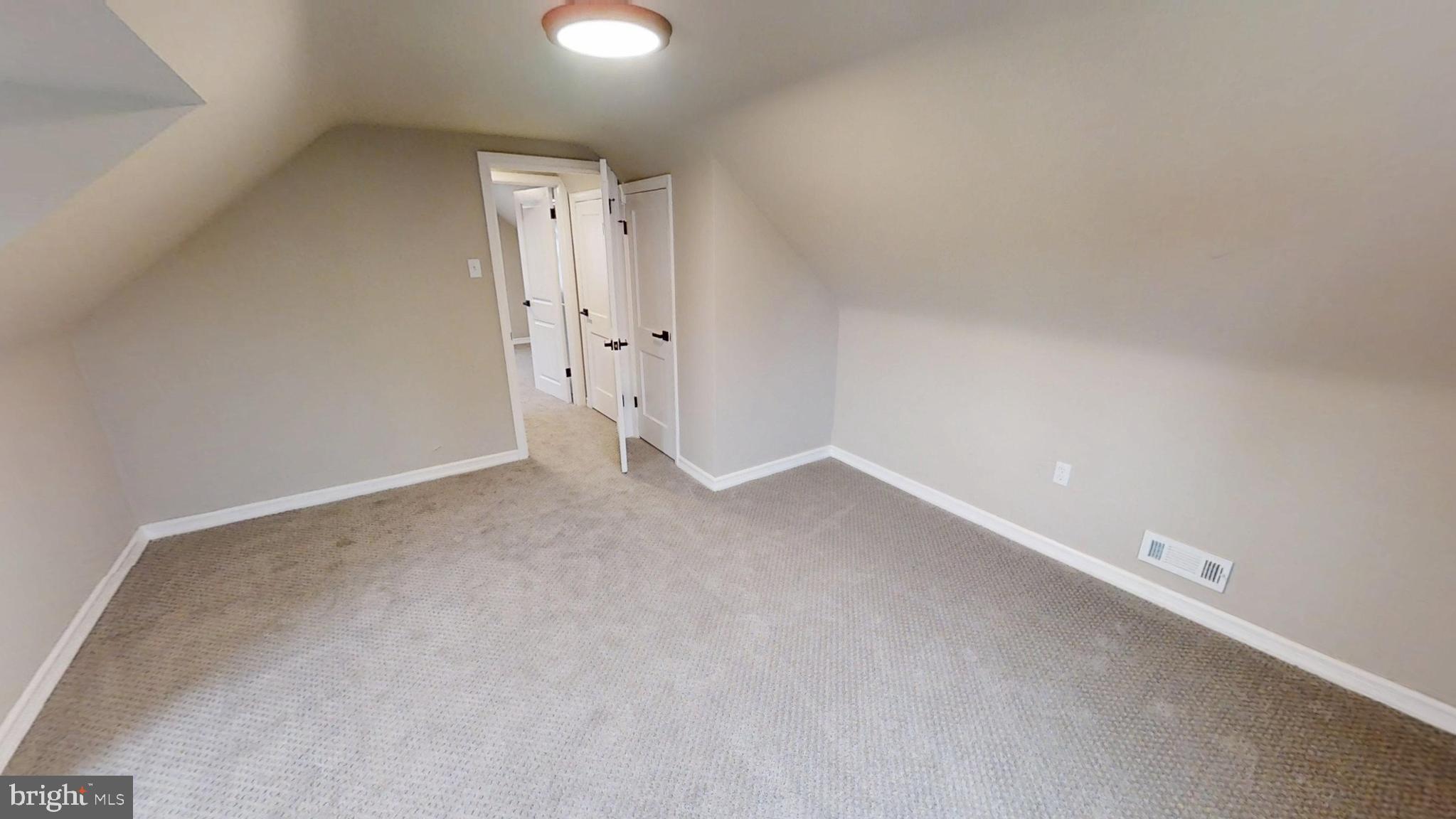 308 Holy Cross Road Baltimore, MD 21225 - Photo 15 of 28 an empty room with an entryway and wooden floor