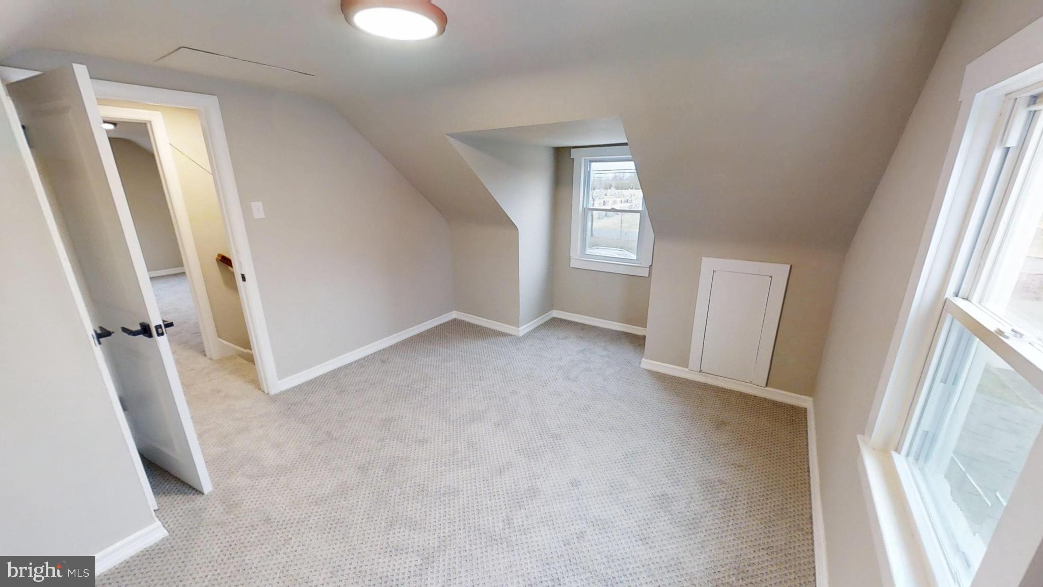 308 Holy Cross Road Baltimore, MD 21225 - Photo 17 of 28 an empty room with windows and entrance