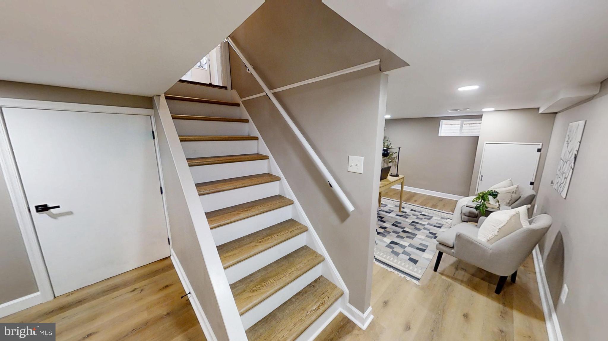 308 Holy Cross Road Baltimore, MD 21225 - Photo 18 of 28 a view of entryway with stairs and wooden floor
