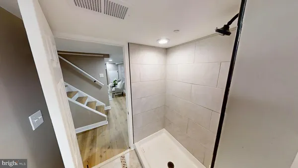 a bathroom with a shower and a mirror