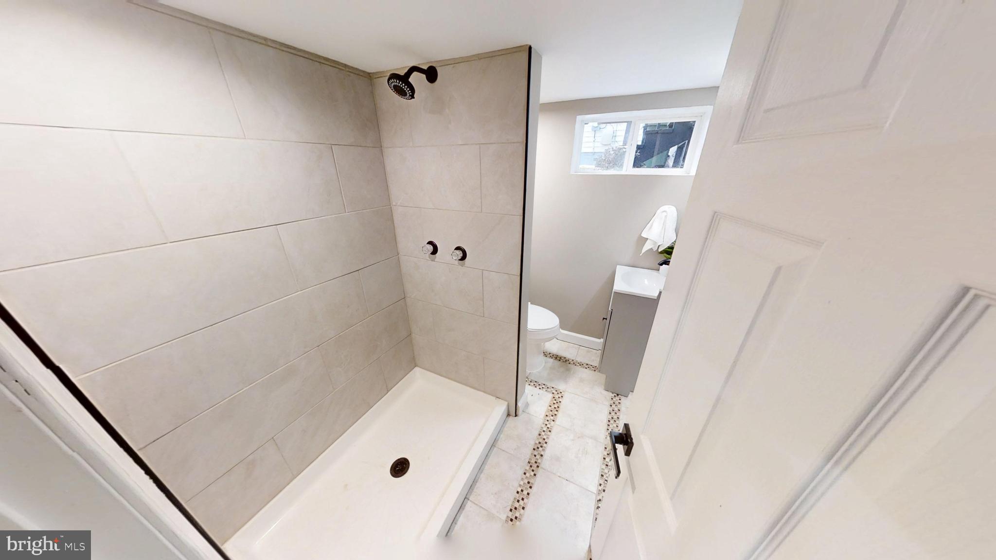 308 Holy Cross Road Baltimore, MD 21225 - Photo 23 of 28 a bathroom with a sink and a shower