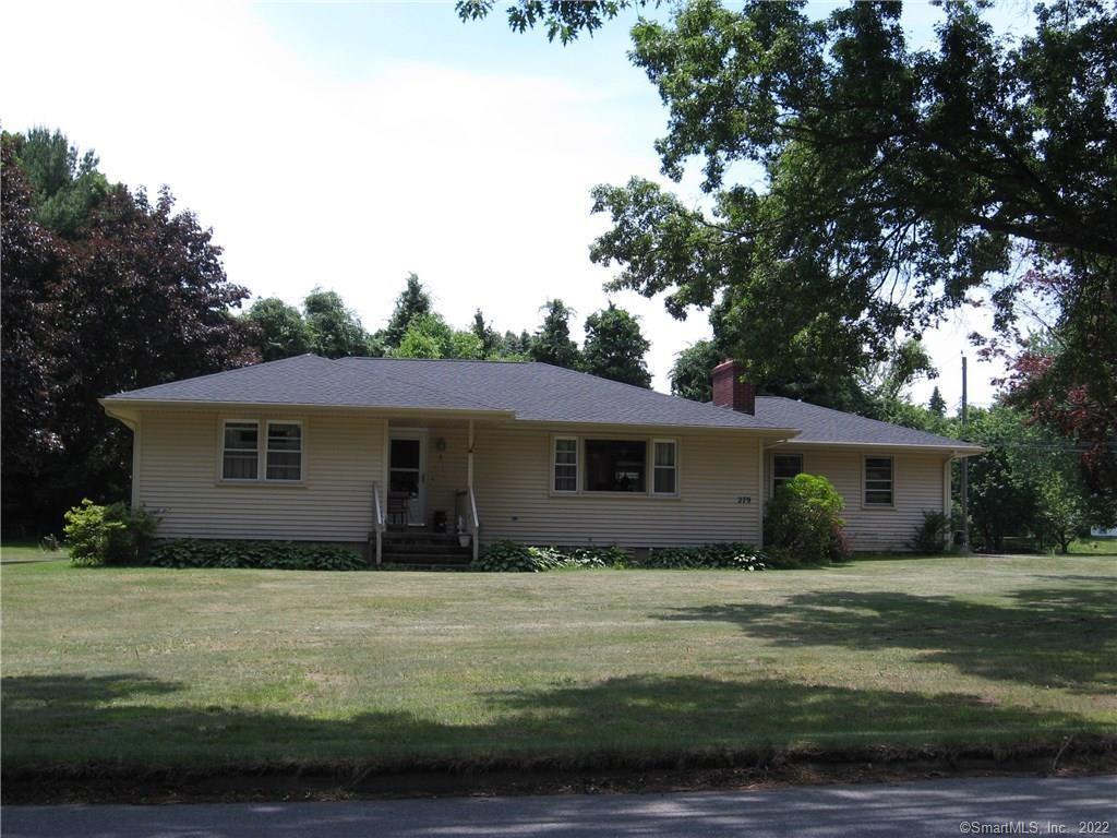 a house that has a tree in front of it