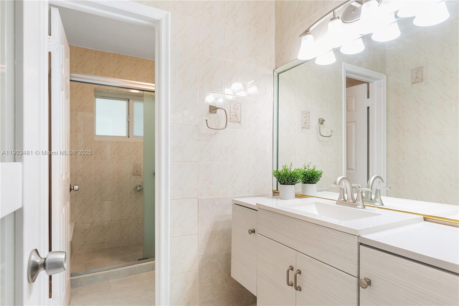 2670 Southwest 119th Court Miami, FL 33175 - Photo 18 of 39 a bathroom with a sink vanity and a mirror