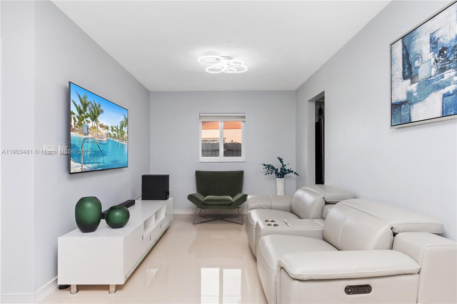 2670 Southwest 119th Court Miami, FL 33175 - Photo 4 of 39 a living room with furniture and a flat screen tv