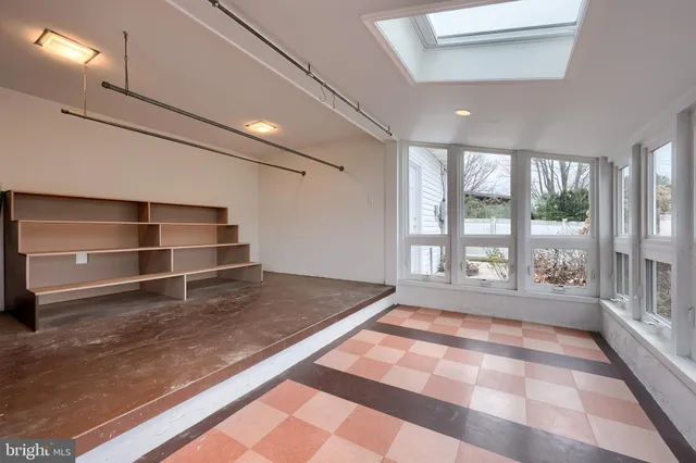 a bathroom with a granite countertop toilet a sink and a mirror