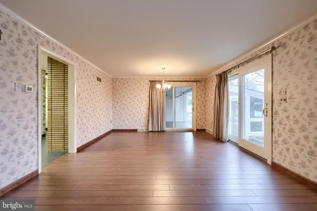 a view of a room with stairs and wooden floor