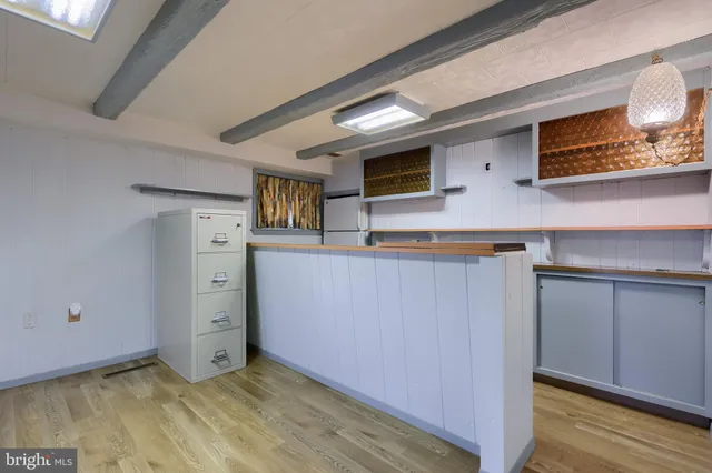 a bathroom with a sink toilet a mirror and shower