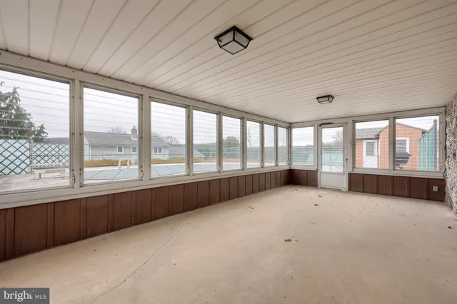a front view of house with yard and trees around
