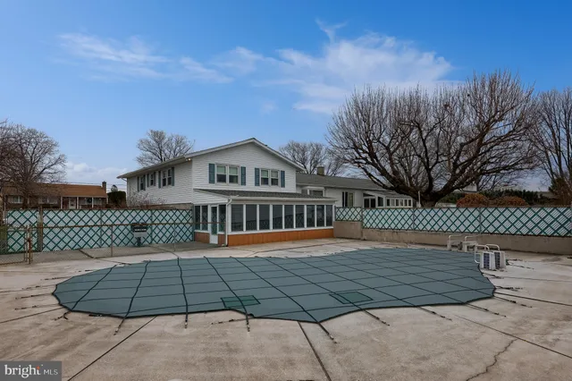 an aerial view of a residential houses with outdoor space and seating
