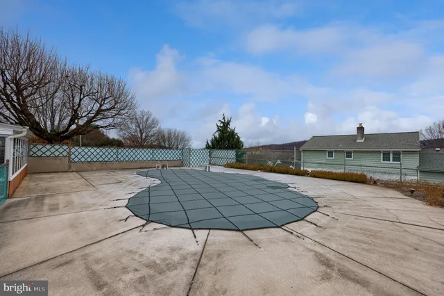 an aerial view of a residential houses with outdoor space