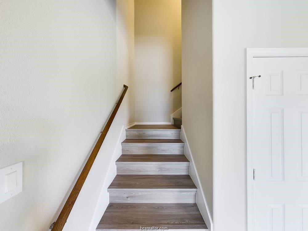 2910 Town Square Avenue, Unit 2111 Bryan, TX 77802 - Photo 5 of 9 a view of staircase with white walls