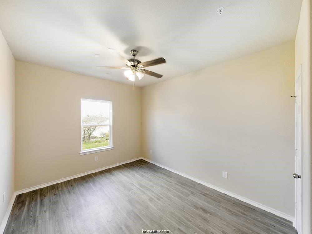 2910 Town Square Avenue, Unit 2111 Bryan, TX 77802 - Photo 9 of 9 an empty room with wooden floor and windows