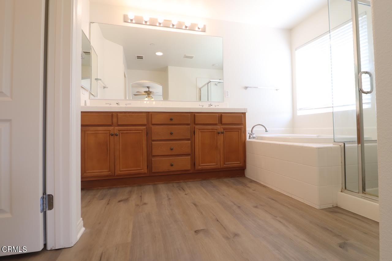 5200 Edgar Street Oxnard, CA 93033 - Photo 19 of 20 a spacious bathroom with a double vanity sink a mirror and a bathtub