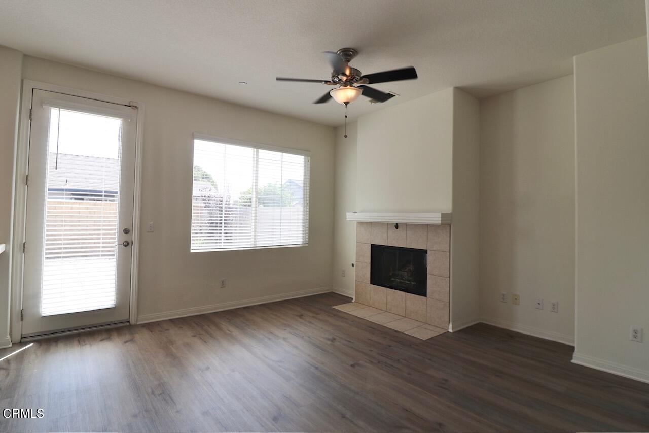 5200 Edgar Street Oxnard, CA 93033 - Photo 5 of 20 a view of an empty room with wooden floor fireplace and a window