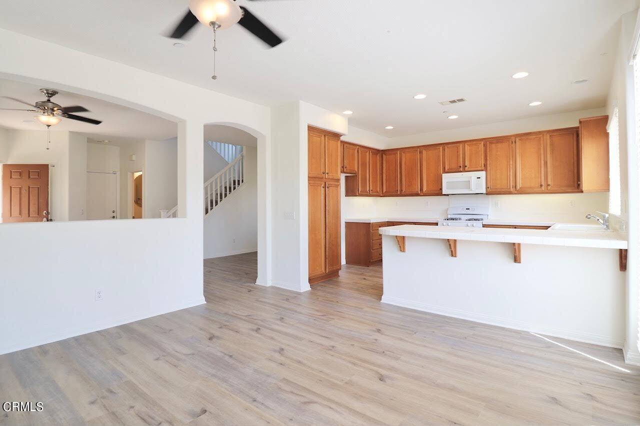 5200 Edgar Street Oxnard, CA 93033 - Photo 7 of 20 a view of kitchen with granite countertop cabinets and refrigerator