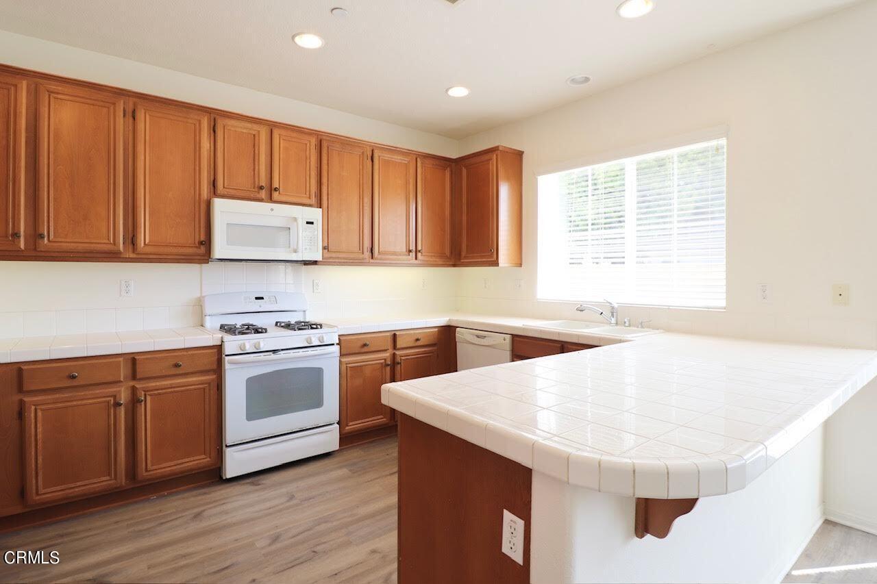 5200 Edgar Street Oxnard, CA 93033 - Photo 8 of 20 a kitchen with stainless steel appliances granite countertop a sink and a stove