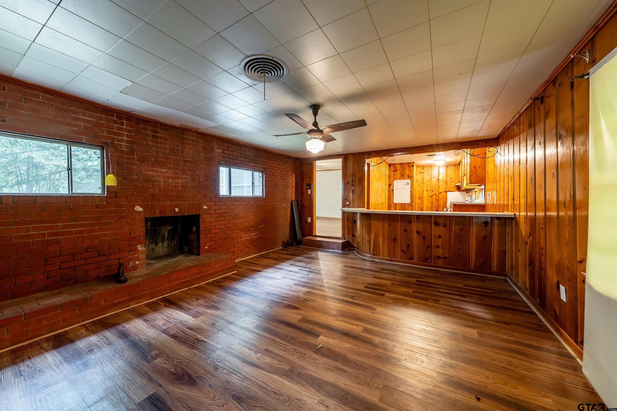 274 West Hill Street Rusk, TX 75785 - Photo 12 of 26 a view of an empty room with wooden floor and a window