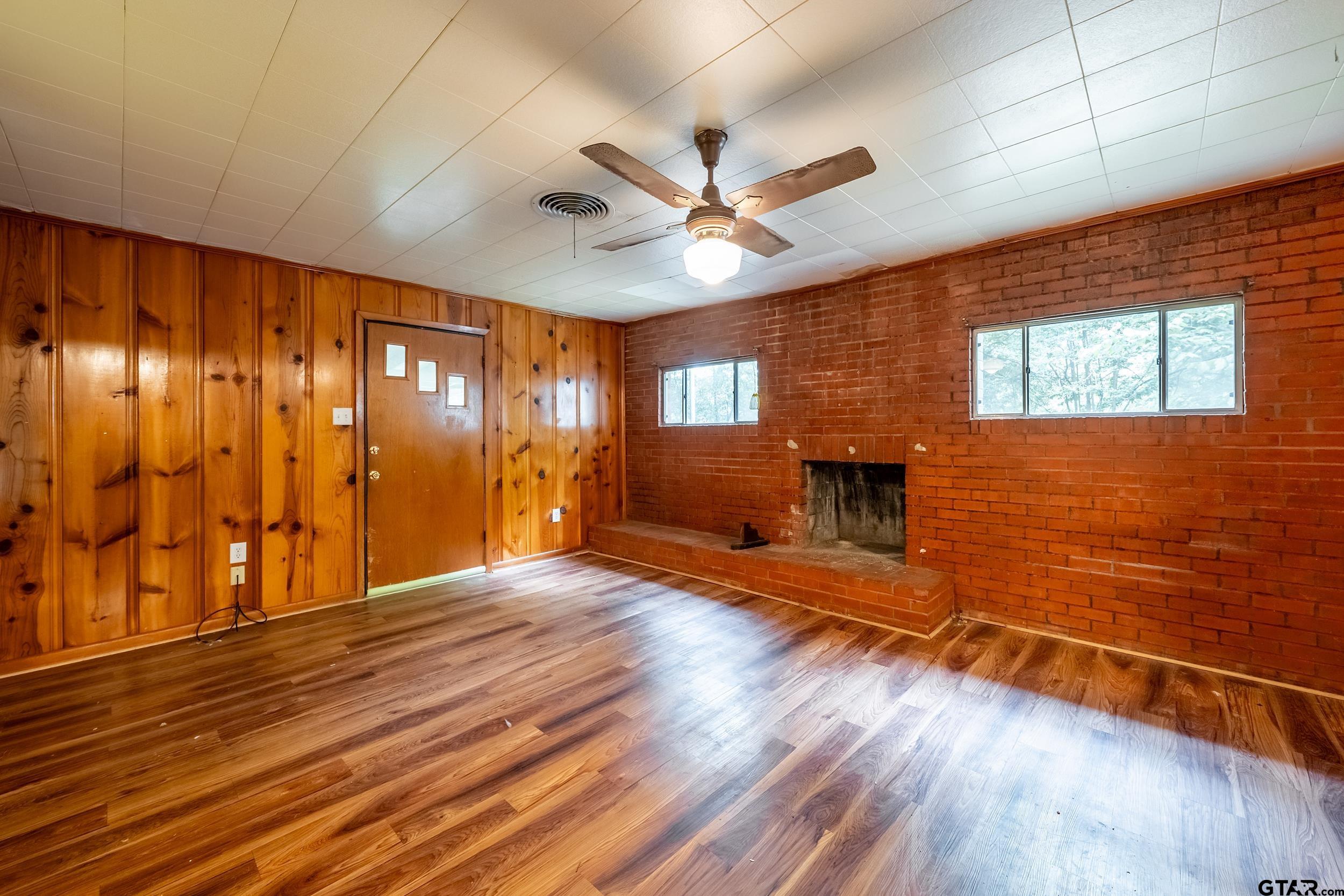 274 West Hill Street Rusk, TX 75785 - Photo 13 of 26 a view of an empty room with a window and wooden floor