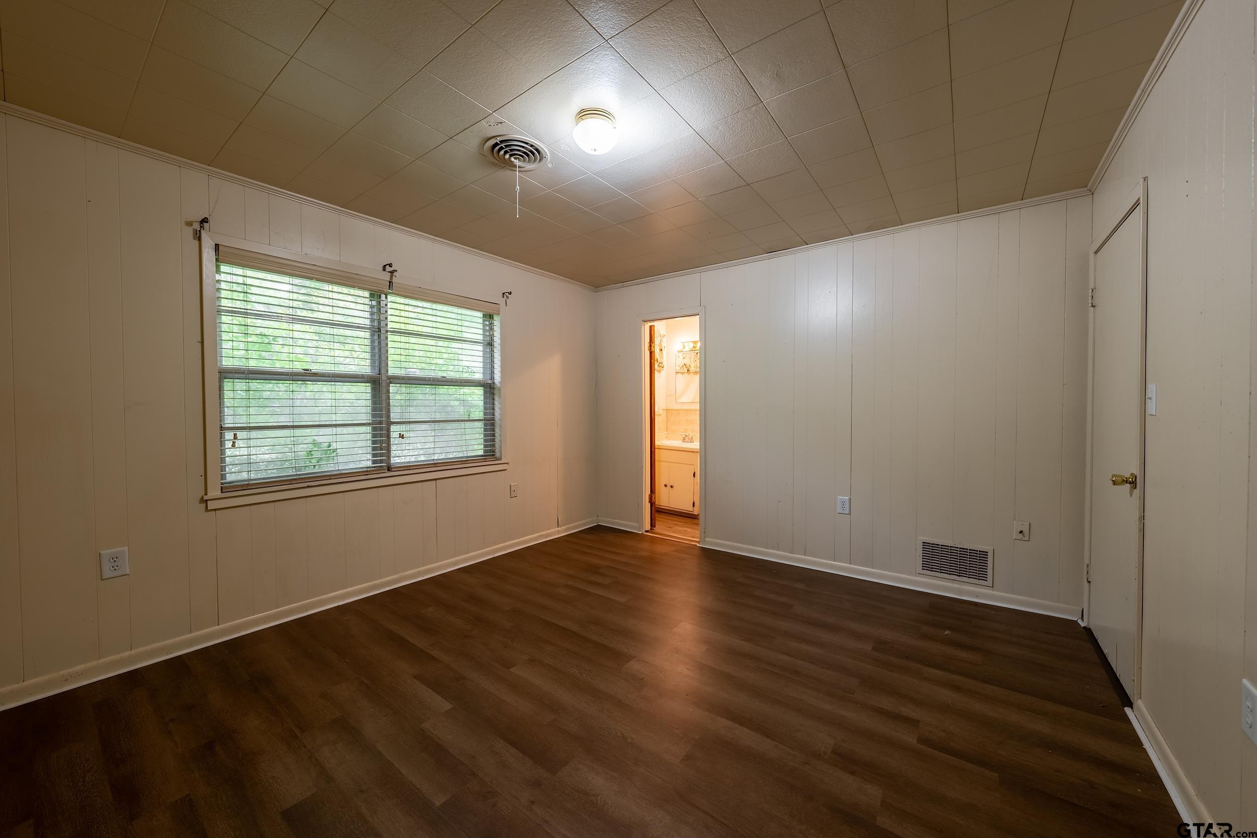 274 West Hill Street Rusk, TX 75785 - Photo 14 of 26 an empty room with wooden floor and windows