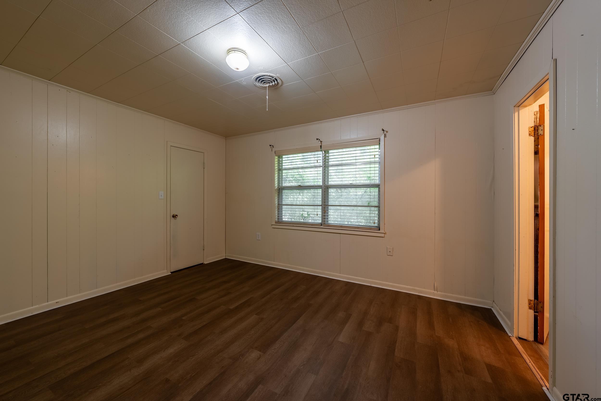 274 West Hill Street Rusk, TX 75785 - Photo 15 of 26 an empty room with wooden floor and windows