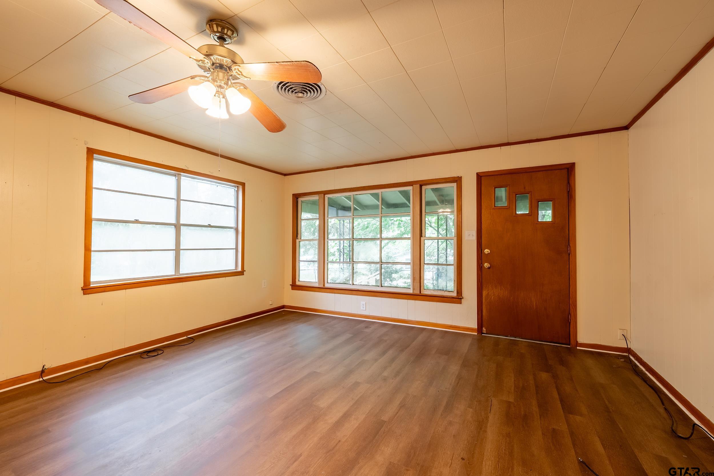 274 West Hill Street Rusk, TX 75785 - Photo 22 of 26 a view of an empty room with a window and wooden floor