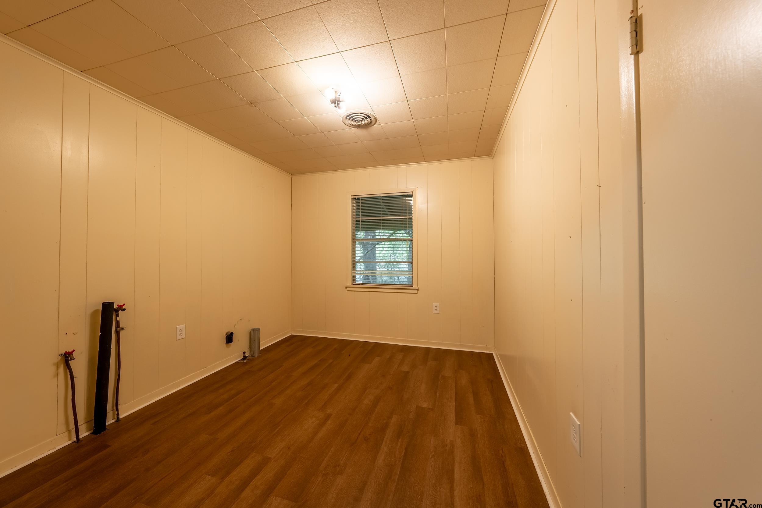 274 West Hill Street Rusk, TX 75785 - Photo 25 of 26 an empty room with wooden floor and windows